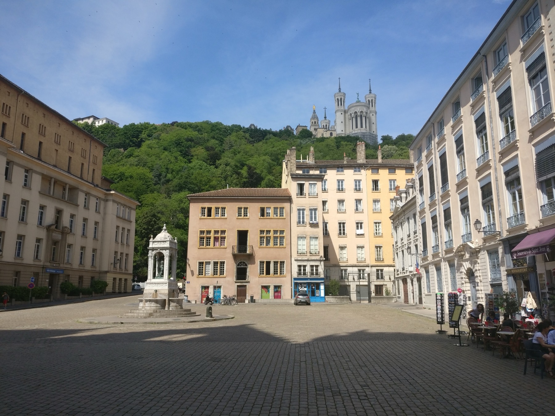 A wide square in Lyon with Fourviere above it